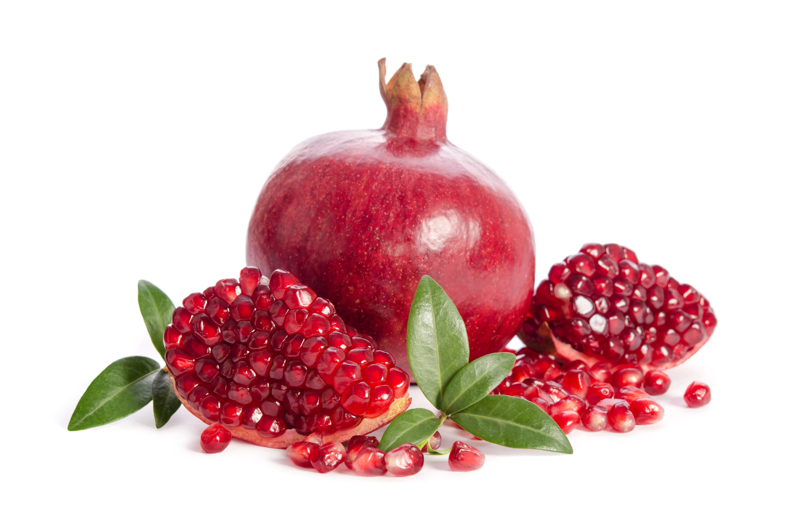 one whole and part of a pomegranate with pomegranate seeds and leaves isolated on white background